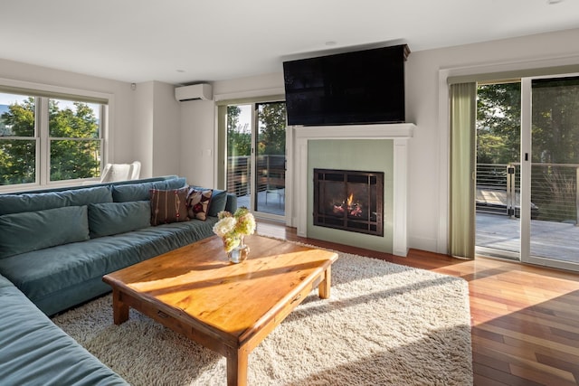 living room with hardwood / wood-style floors and an AC wall unit