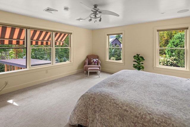 unfurnished bedroom featuring carpet flooring, ceiling fan, and multiple windows