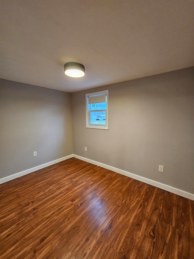 spare room featuring dark wood-type flooring