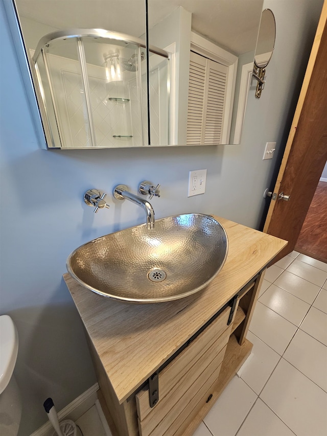 bathroom with tile patterned floors, vanity, and an enclosed shower