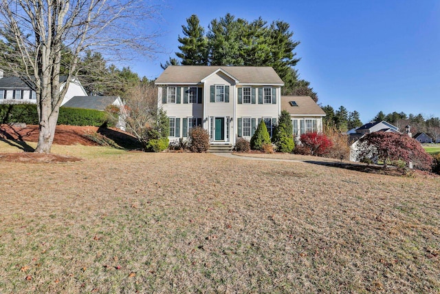 colonial home with a front yard