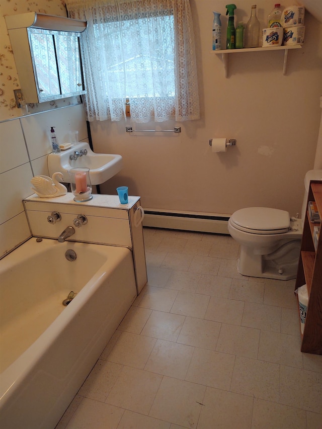 bathroom with a baseboard radiator, toilet, plenty of natural light, and sink