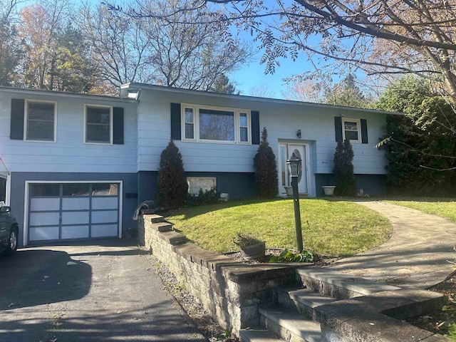 bi-level home featuring a garage and a front yard