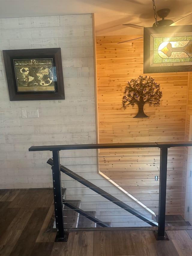 corridor with wood walls and hardwood / wood-style floors