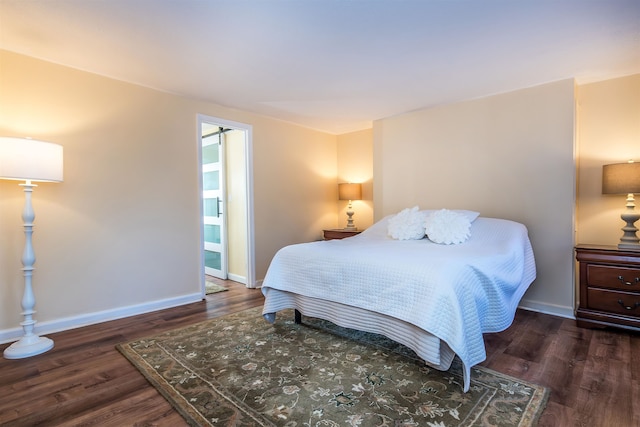 bedroom with dark hardwood / wood-style flooring