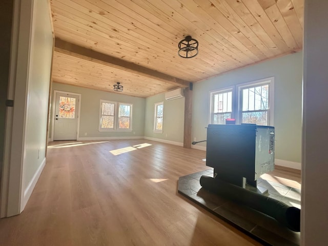 workout room featuring wood-type flooring, wooden ceiling, a wall mounted AC, and a healthy amount of sunlight