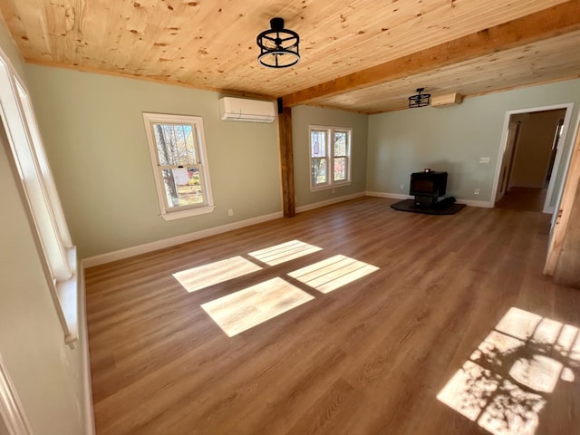 interior space with light wood-type flooring, a wall mounted AC, beam ceiling, wooden ceiling, and a wood stove