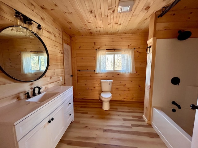 bathroom with vanity, wooden ceiling, hardwood / wood-style floors, toilet, and wood walls