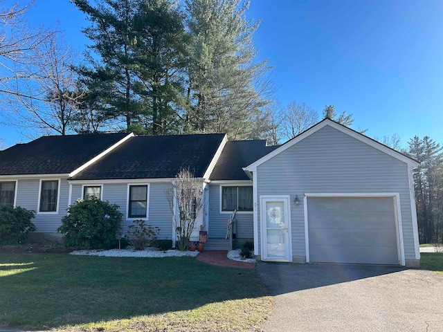 single story home featuring a front yard and a garage