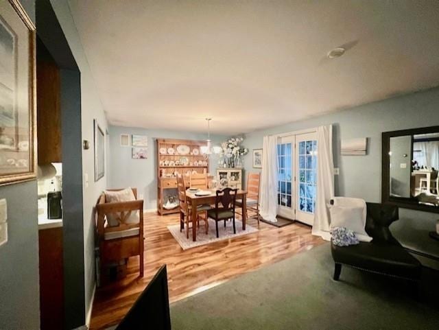 dining space featuring french doors and hardwood / wood-style flooring