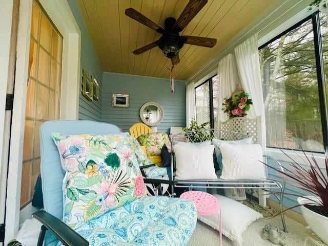 sunroom / solarium with ceiling fan and wooden ceiling