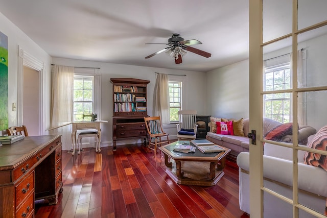 living room with dark hardwood / wood-style flooring, plenty of natural light, and ceiling fan