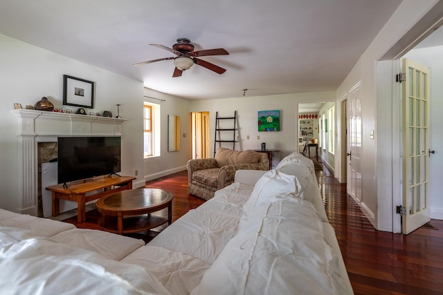 living room with ceiling fan and dark hardwood / wood-style floors