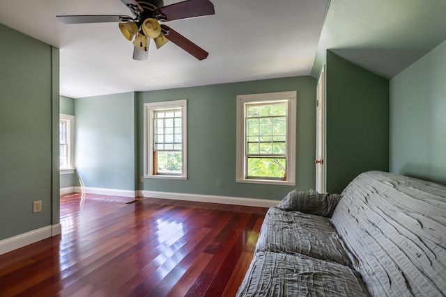 living room with ceiling fan, dark hardwood / wood-style flooring, and vaulted ceiling