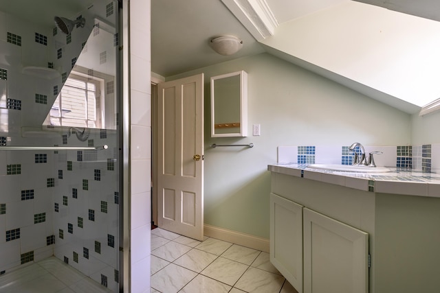 bathroom featuring tile patterned flooring, lofted ceiling, a shower with door, and vanity