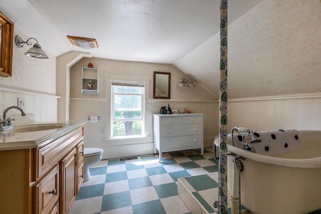 bathroom with a tub to relax in, vanity, toilet, lofted ceiling, and wood walls