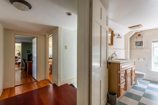 bathroom featuring hardwood / wood-style floors, vanity, and toilet