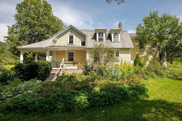 rear view of property with covered porch