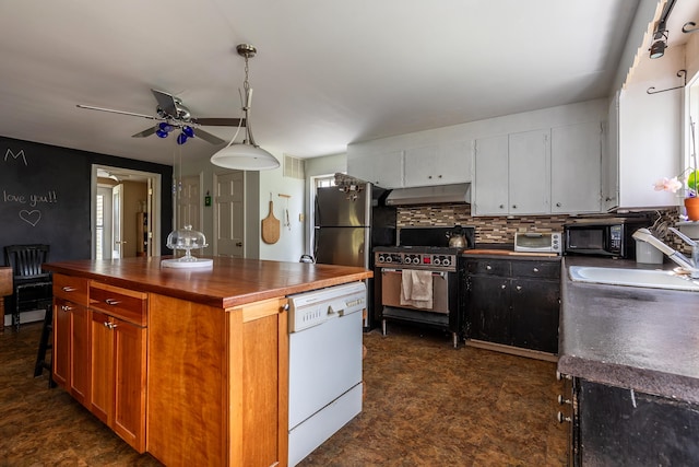 kitchen with sink, high end range oven, white dishwasher, decorative light fixtures, and white cabinets