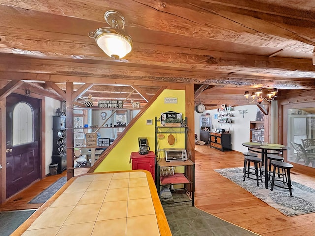 interior space with beamed ceiling, wood-type flooring, and wooden ceiling