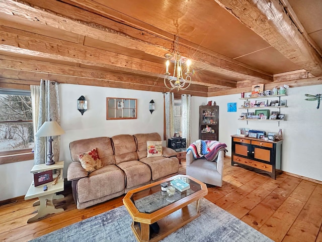 living room featuring beam ceiling, hardwood / wood-style flooring, and a notable chandelier