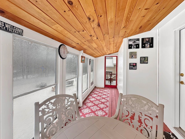 sunroom featuring lofted ceiling and wood ceiling