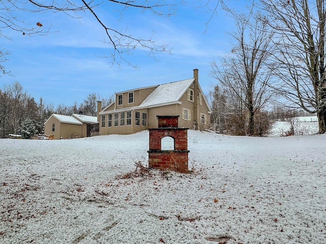 snow covered property featuring a sunroom