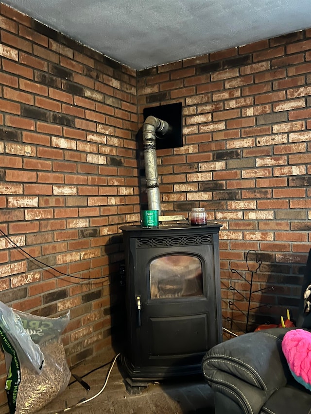 interior details featuring a wood stove and a textured ceiling