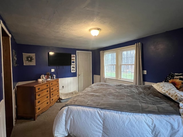 carpeted bedroom featuring a textured ceiling