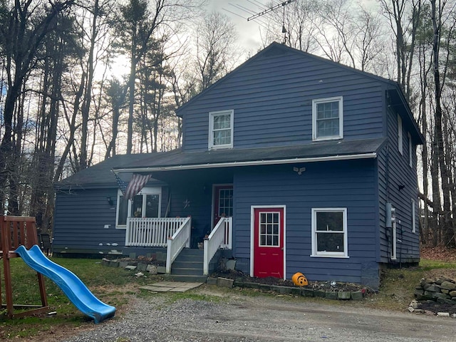 view of front of property featuring a porch and a playground