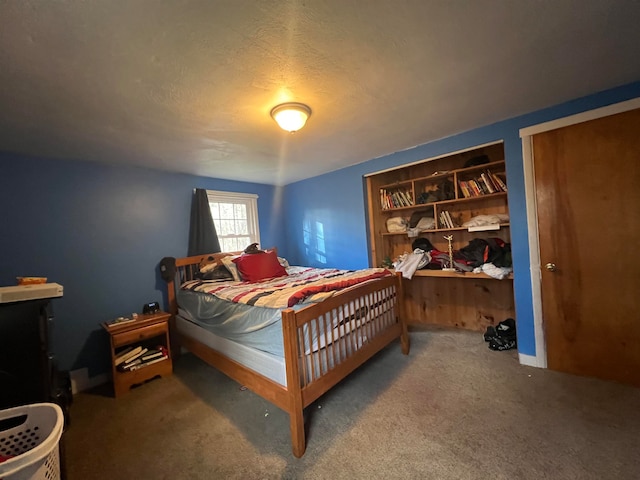 bedroom featuring carpet and a textured ceiling