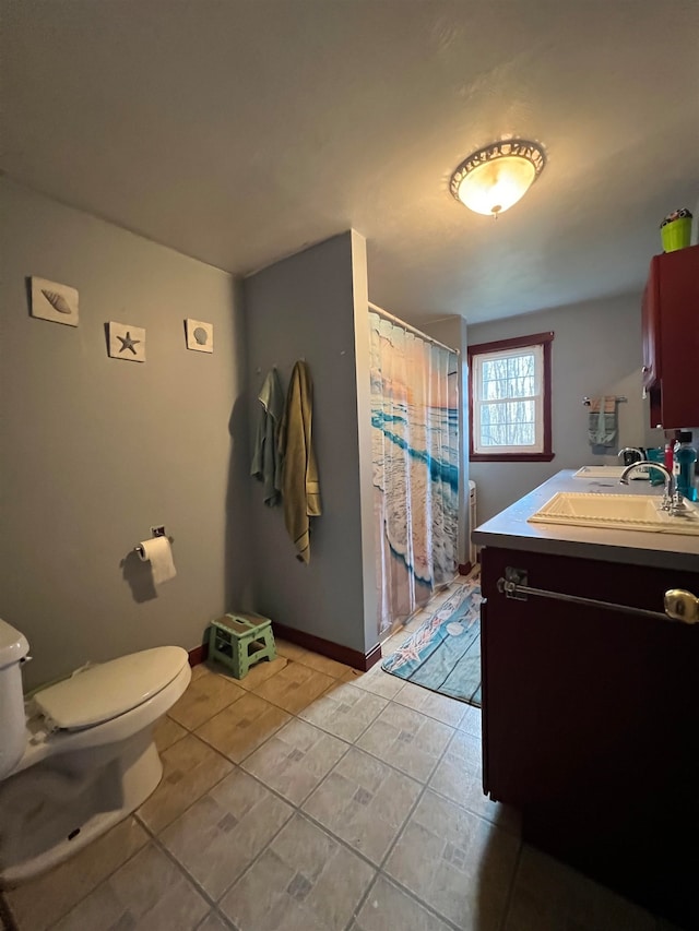 bathroom featuring tile patterned floors, vanity, a shower with shower curtain, and toilet