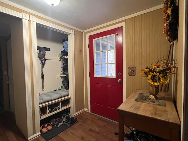 doorway featuring ornamental molding and dark wood-type flooring