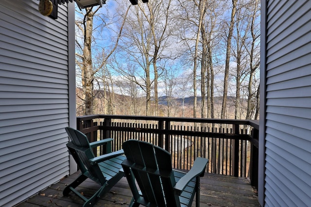 wooden deck with a mountain view