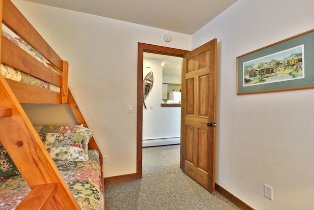 carpeted bedroom featuring a baseboard radiator