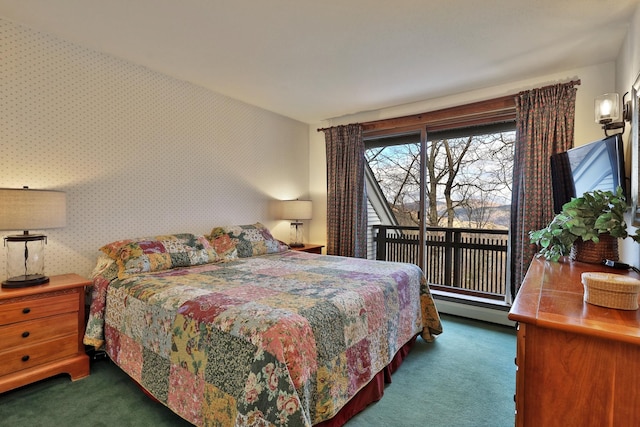 bedroom with dark colored carpet, access to exterior, and baseboard heating