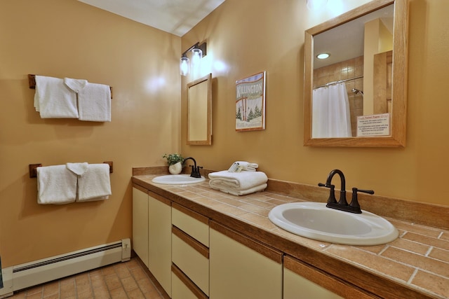 bathroom featuring vanity, curtained shower, and a baseboard heating unit