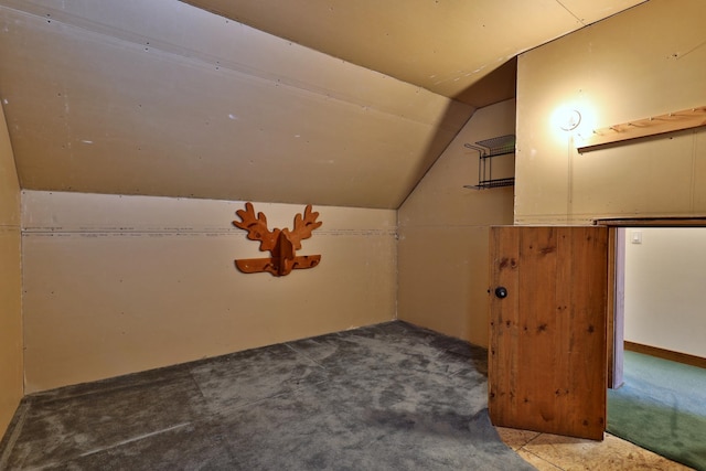 bonus room with carpet and vaulted ceiling