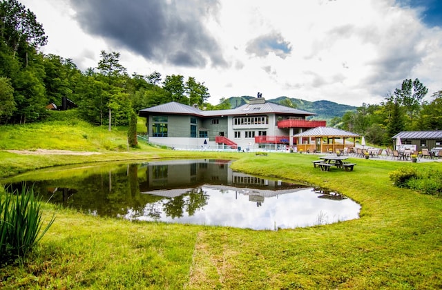 back of house with a gazebo, a yard, and a water and mountain view