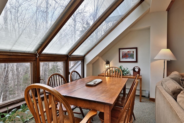 carpeted dining room featuring lofted ceiling and baseboard heating