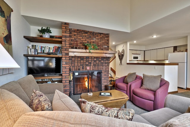 living room featuring a brick fireplace