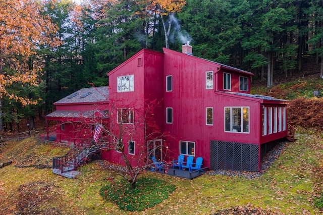 view of property exterior featuring a yard and a deck