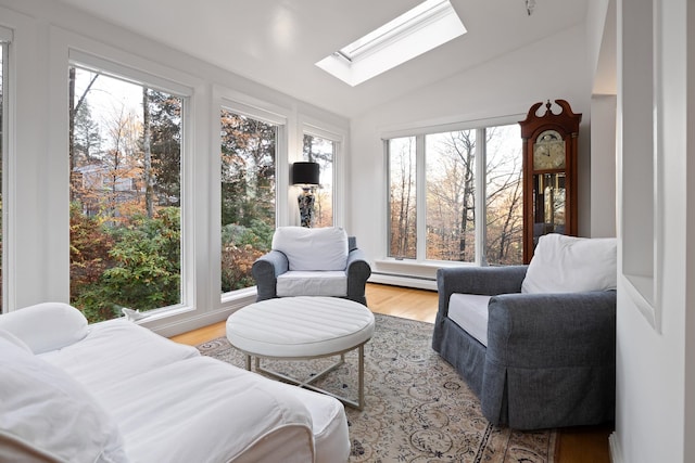 sunroom / solarium with vaulted ceiling with skylight, a wealth of natural light, and a baseboard radiator