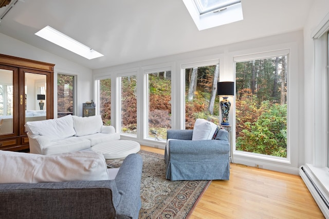 sunroom / solarium with baseboard heating and lofted ceiling with skylight