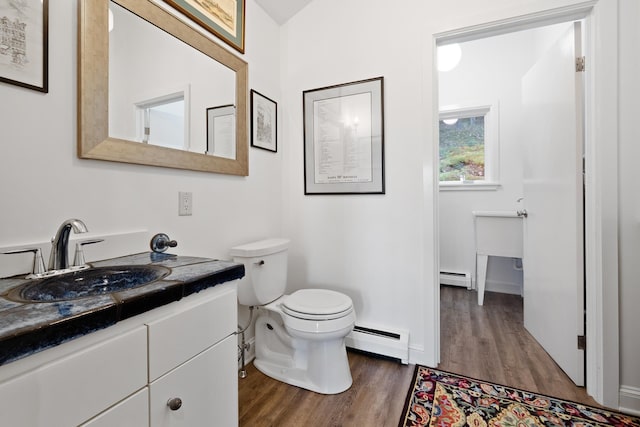 bathroom with vanity, a baseboard radiator, toilet, and hardwood / wood-style flooring