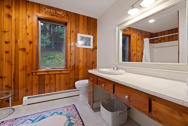 bathroom with curtained shower, baseboard heating, tile patterned flooring, toilet, and wooden walls