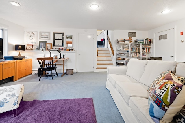 carpeted living room with a textured ceiling