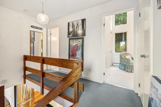 hall featuring dark carpet and a baseboard radiator