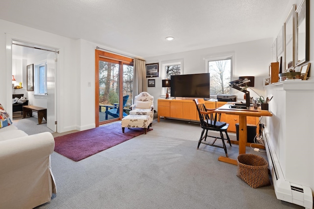 office space featuring light carpet and a textured ceiling