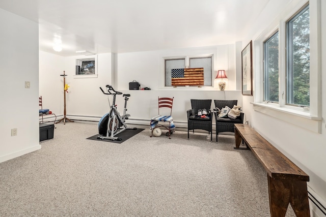 workout area featuring carpet and a baseboard heating unit